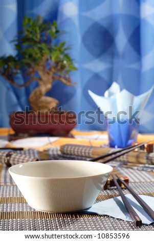 Asian decorated table, soup bowl in the foreground
