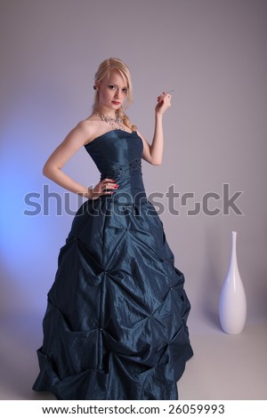Beautiful young woman wearing a blue prom dress