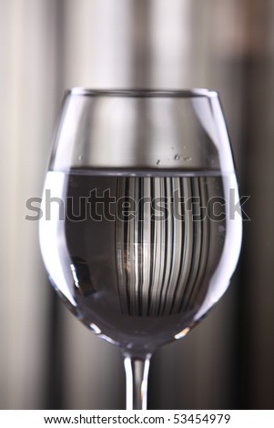 Wine glasses against striped background with dramatic lighting