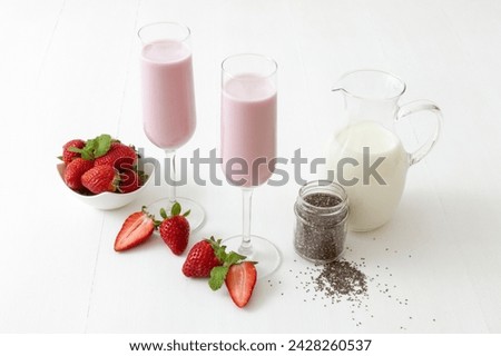 Similar – Image, Stock Photo Strawberry smoothie. Two glasses of berry slush. Summer cold drink