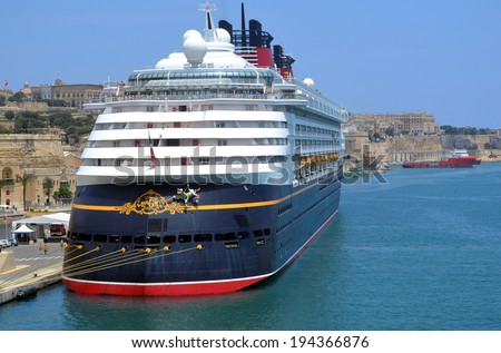 VALLETTE, MALTA - MAY 30 Cruise liner Disney Magic at Port of Valletta, Malta - May 30, 2011: Cruise liner docked in port of Valetta, is waiting for the passengers who\'s having promenade in the capital of Malta to board.