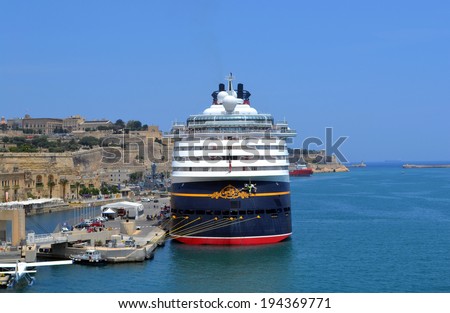 VALLETTA, MALTA - MAY 30 - Cruise liner Disney Magic at Port of Valletta, Malta - May 30, 2011: Cruise liner docked in port of Valetta, is waiting for the passengers who\'s having promenade in the capital of Malta to board.
