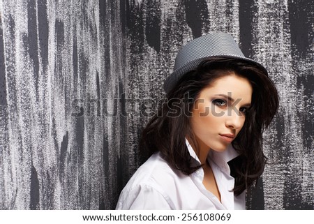 Portrait of a beautiful natural girl on a grunge background.