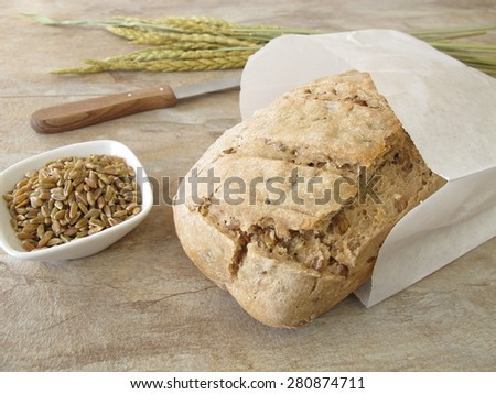 Homemade green spelt bread in paper bag