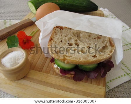 Cucumber sandwich in greaseproof paper bag for take away