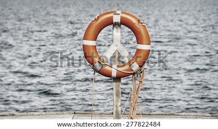 life belt, rescue ring, water in background