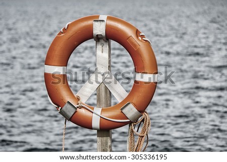 life belt, rescue ring, water in background