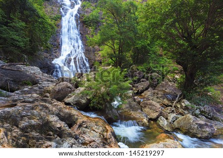 Waterfall in thai national park. In the deep forest on mountain.