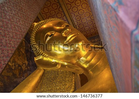 BANGKOK ,THAILAND - JULY 4 : Reclining Buddha gold statue face in Wat Pho on July 4, 2013 in Bangkok, Thailand