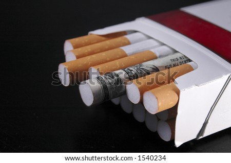 A cigarette wrapped in a dollar bill in a pack of cigarettes.