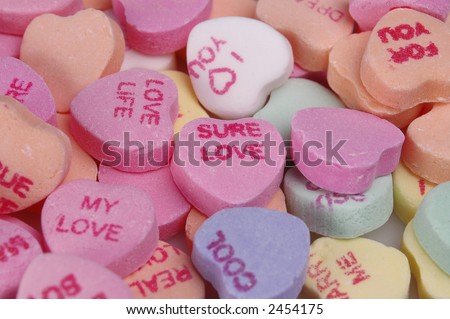 A closeup of a pile of candy hearts. Good for use as a background.