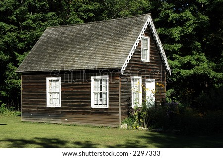 Wood cabin / house / home with white trim and pretty yellow flowers