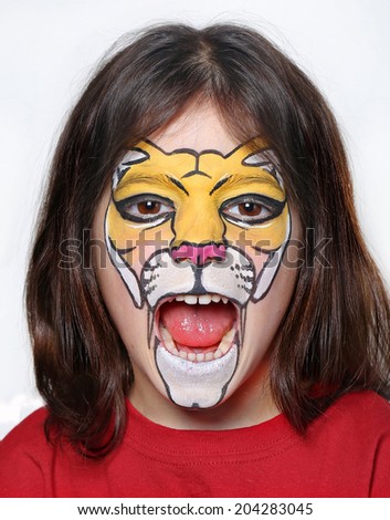 Pretty girl with face painting of a lion.