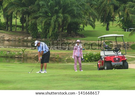 PATTAYA, THAILAND - MAY 29: Unidentified man addressing the the ball on 7th hole at Green Valley St Andrews golf course on May 29, 2013. Pattaya has 25 golf courses close to the city.