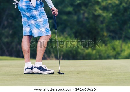 PATTAYA, THAILAND - MAY 29: Unidentified man on green at 4th hole at Green Valley St Andrews golf course on May 29, 2013. Pattaya has 25 golf courses close to the city.