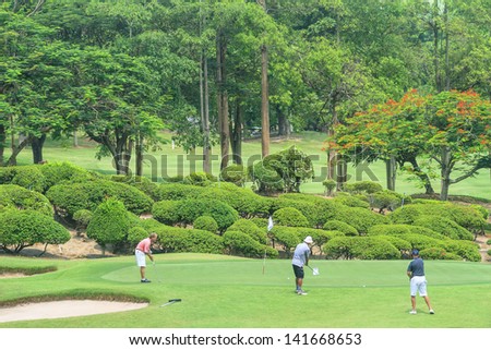 PATTAYA, THAILAND - MAY 29: Unidentified men putting on green at 8th hole at Green Valley St Andrews golf course on May 29, 2013. Pattaya has 25 golf courses close to the city.