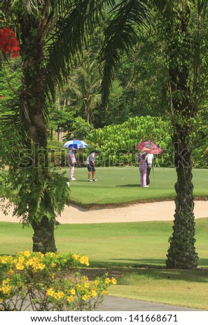PATTAYA, THAILAND - MAY 29: Unidentified man putting on 8th hole on Green Valley St Andrews golf course on May 29, 2013. Pattaya has 25 golf courses close to the city.