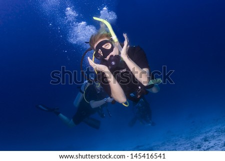 KHAO LAK, THAILAND - OCTOBER 25: Female scuba diver exploring a dive site in Similan Islands on October 25, 2009 . Similan Islands are Thailand's premier dive destination for foreign dive tourists.