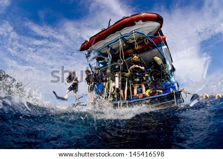 KHAO LAK, THAILAND - NOVEMBER 26: A group of scuba divers jump in the water from a liveaboard dive boat in Similan Islands on November 26, 2010 . Similan Islands are Thailand\'s premier diving area.