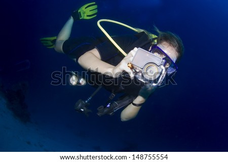 KHAO LAK, THAILAND - NOVEMBER 24: Female scuba diver photographing underwater in Similan Islands on November 24, 2009 . Similan Islands are Thailand's premier dive destination.