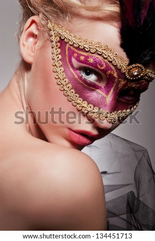 Beautiful woman in Venetian mask violet color with gold border