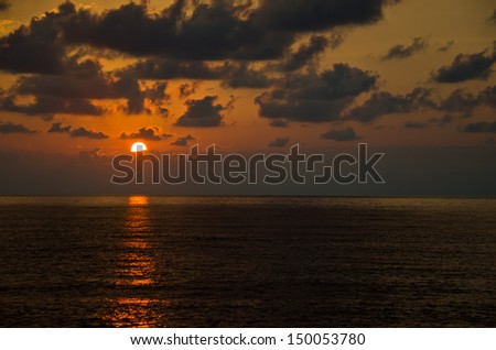 Golden sunset on the sea. Sun in orange clouds