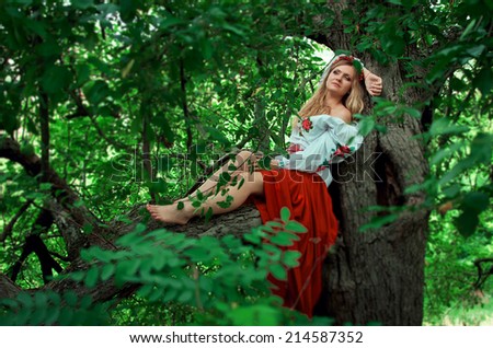Beautiful woman in the Ukrainian national dress in an apple orchard