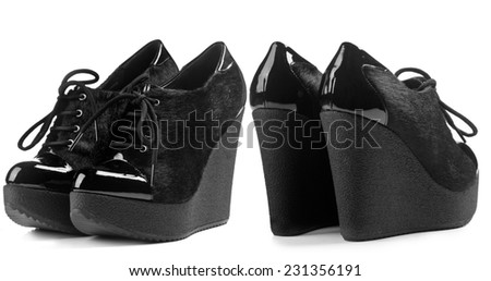 A pair of fur shoe on high wedge heels isolated on white background. Front view, rear view
