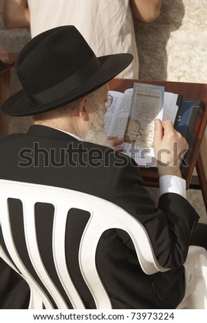 JERUSALEM - APRIL 4: Unidentified senior Israeli Orthodox reading the sacred writings on the Western Wall on April 4, 2008 in Jerusalem.