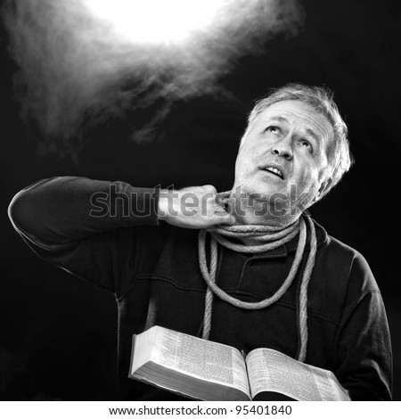 Man with Bible and trying to untie the rope from his neck (loose thyself from the bands of thy neck.. Isaiah 52:2 )
