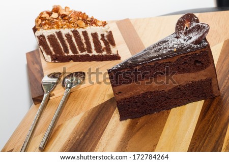 chocolate cake and crispy almond chocolate cake on wood board