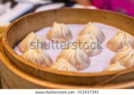 chinese style food called xiao long bao, minced pork and crab dumpling with soup inside