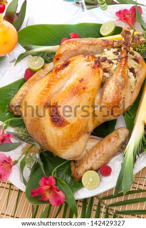 Garnished roasted turkey with tropical fruits, flowers, and refreshing cocktails.