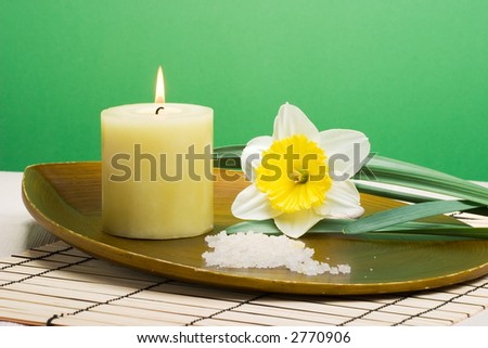 Aroma therapy with candle and spring daffodil flower, suited for spa and healthy lifestyle usage.