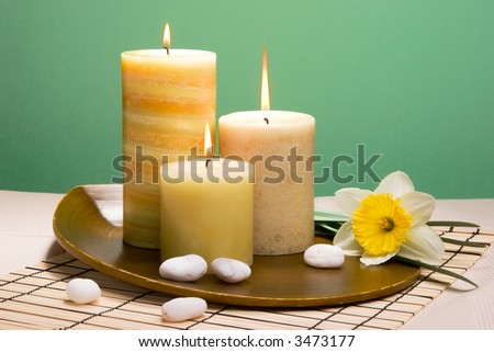 Spring relaxation spa set with candles and spring daffodil flowers, suited for spa and healthy lifestyle usage.