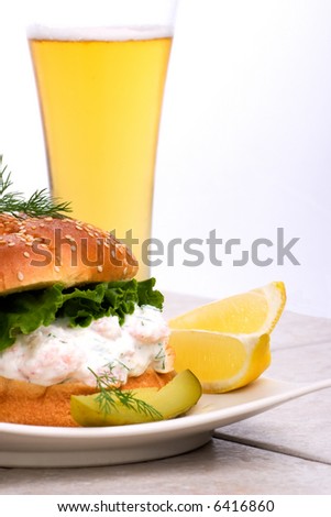 Rich-tasting, but low-calorie filling with shrimps delicious sandwich and glass of lager beer