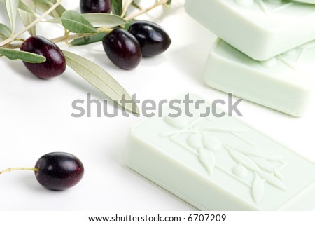 Spa set - fresh black olives, oils, organic soap and towels over white background best suited for relaxing and health commercials