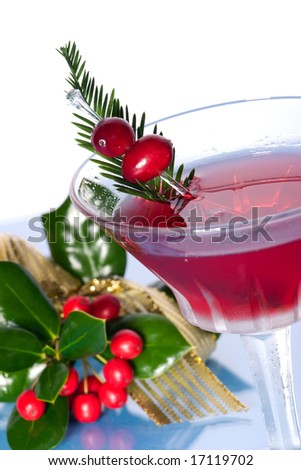 Closeup of Cosmopolitan cocktail in martini glass and Christmas decoration