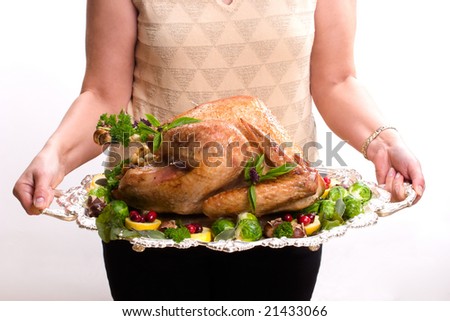 Garnished roasted turkey on platter is ready to be served