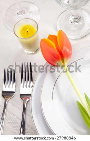 Fine food and wine spring table settings with fresh tulips