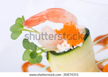 Two Zucchini Rolls with shrimps and seasoned capelin roe (Masago). Garnished with wasabi sauce.