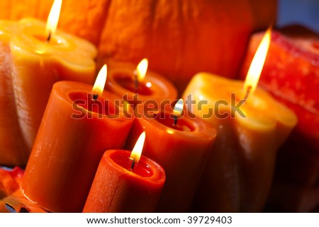 Closeup of festive aromatic candles burning merrily - fall theme