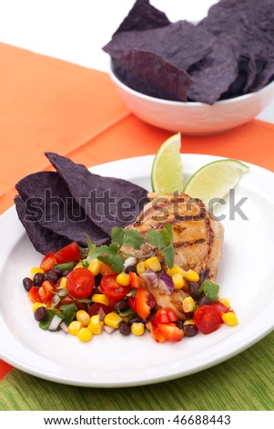 Grilled chicken breast with salsa - black beans, corn, tomatoes, chilli pepper, cilantro, red onion - with  blue corn tortilla chips.