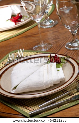 Exotic theme table setting. Arrangements with fresh fern and kangaroo paws flower