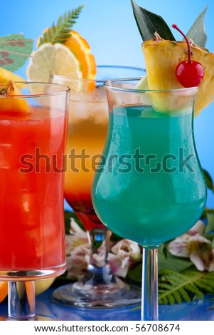 Mai Tai, Blue Hawaiian and Hurricane cocktails surrounded by tropical fruits. Most popular cocktails series.