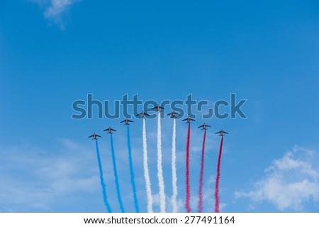 July 14th, 2011: French Air Patrol flying in a blue sky with blue, white and red vapor trails for the French National Day.  Paris, July 14th, 2011