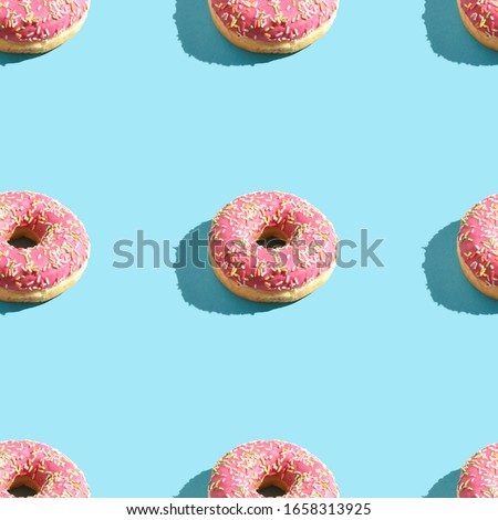 Image, Stock Photo Donuts in a row on blue background. Homemade ring doughnuts, top view