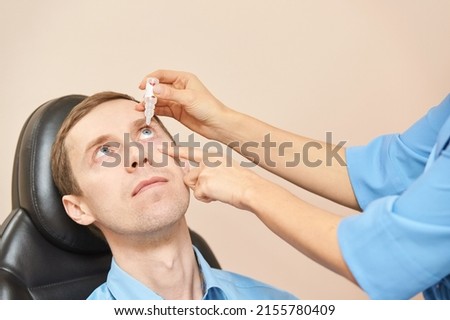 Image, Stock Photo doctor man using a syringe and a vial. using protective mask and gloves during corona virus covid 2019 pandemic. Health care and medical concept