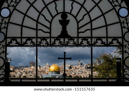 Christianity and Islam. Famous view of Jerusalem through the window of the christian church called Dominus Flevit, located on the slopes of Mount of Olives.