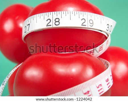 Big Red Tomatoes and Measuring Tape Representing Dieting and Fitness (Close-up with life-like colors)